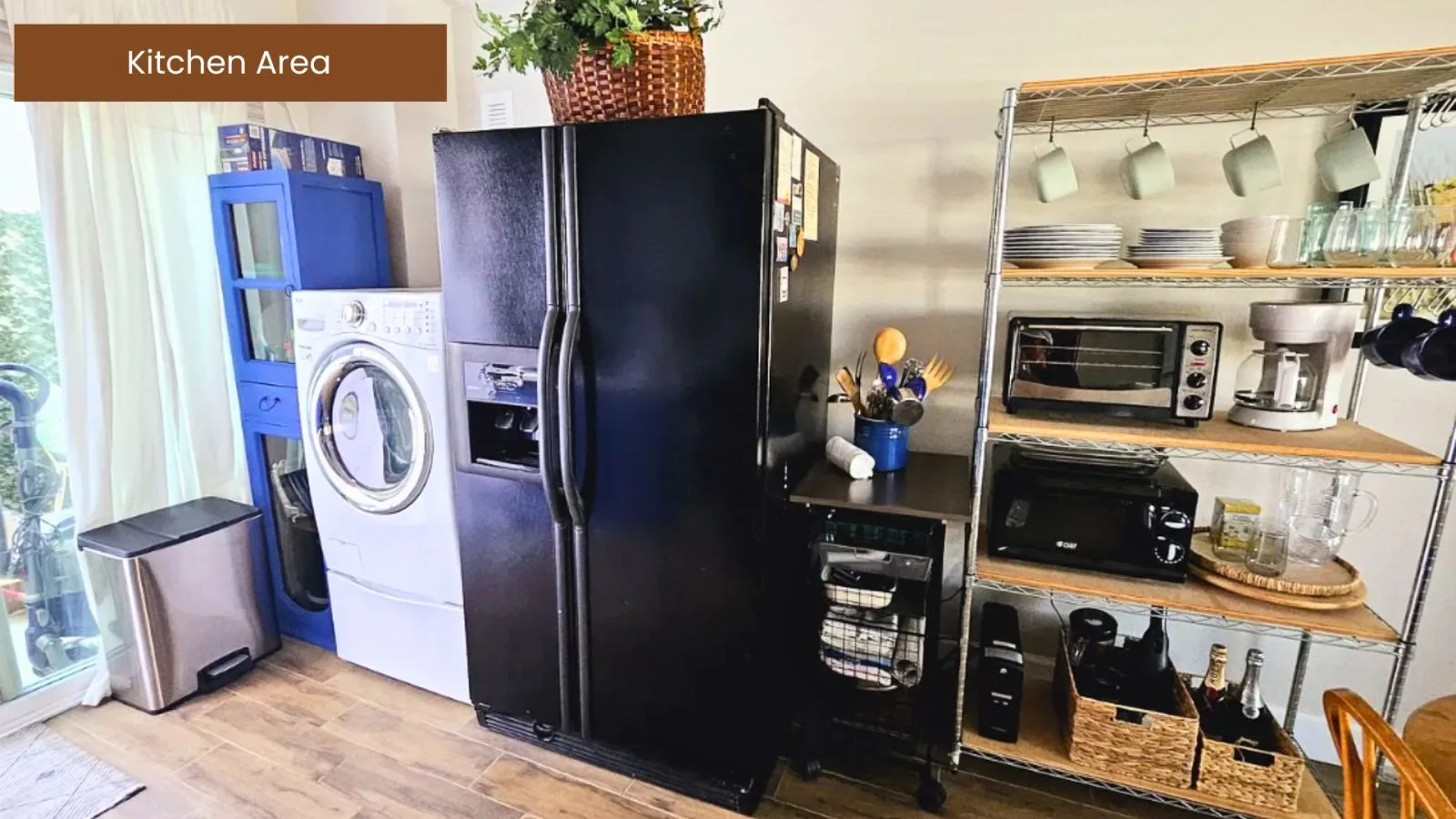 Kitchen area with full-size refrigerator and in-unit laundry
