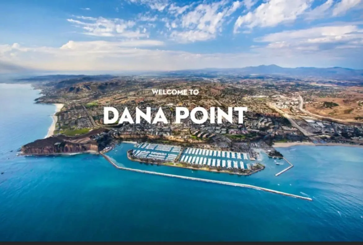 Aerial view of the Dana Point coastline with the Welcome to Dana Point sign