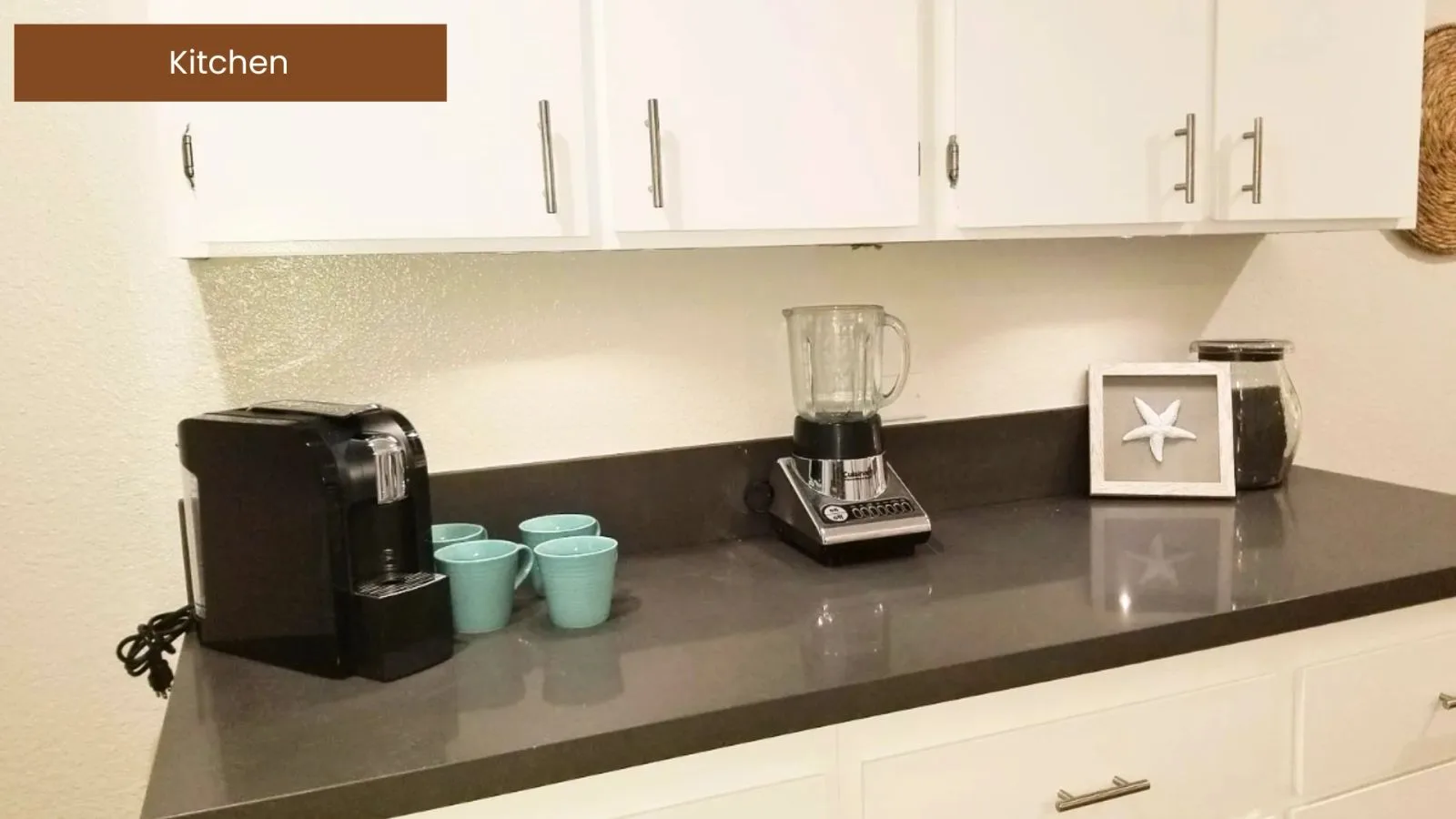 Kitchen counter with coffee maker, blender, and toaster ready for move-in