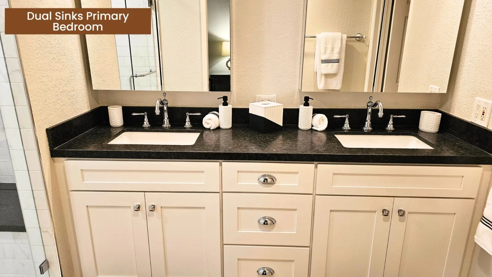 Primary bathroom with dual sinks and abundant storage