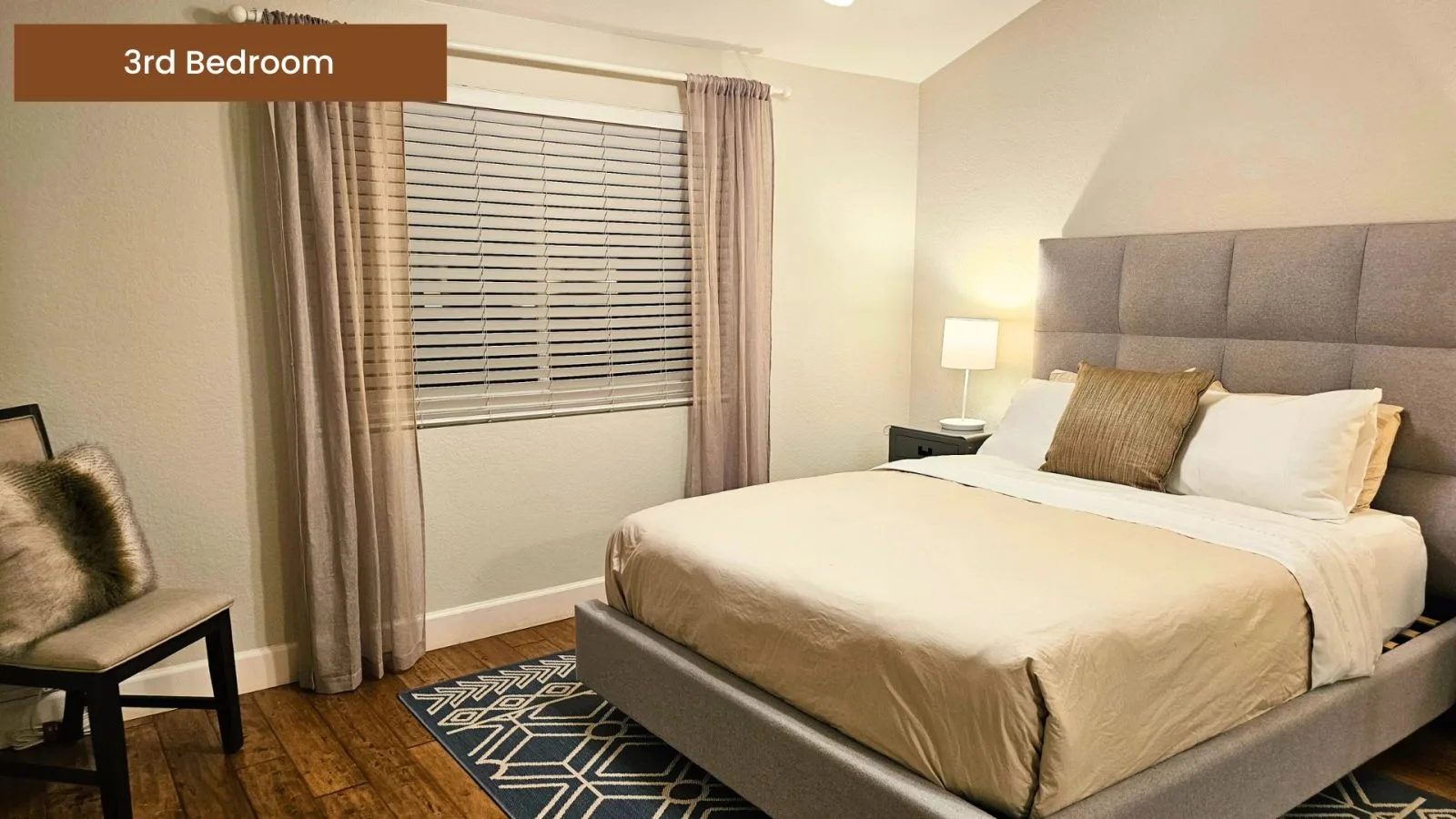 Third bedroom with a queen bed and soft window light