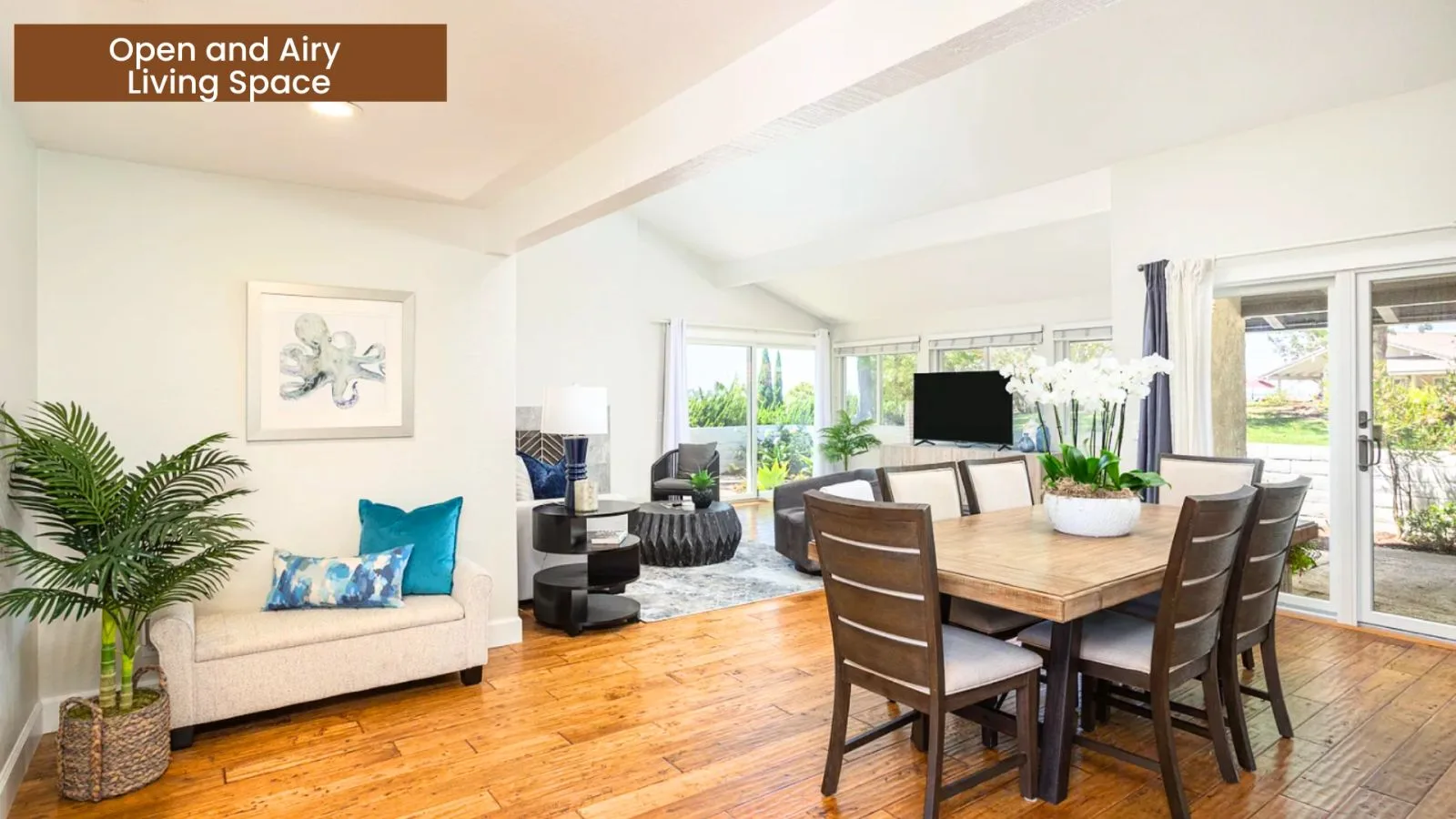 Open and airy living and dining space with vaulted ceilings and natural light