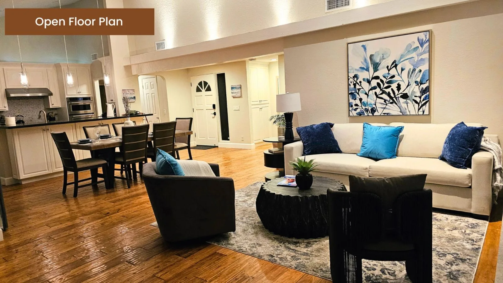 Open floor plan connecting the lounge and dining areas over hardwood floors