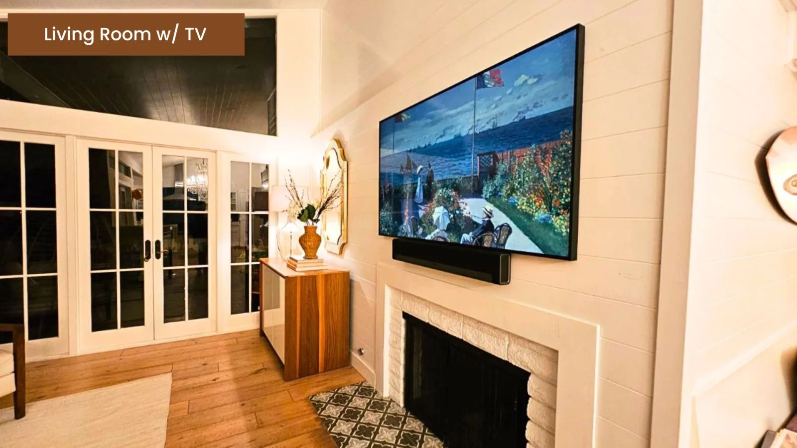 Living room with a mounted TV above the fireplace