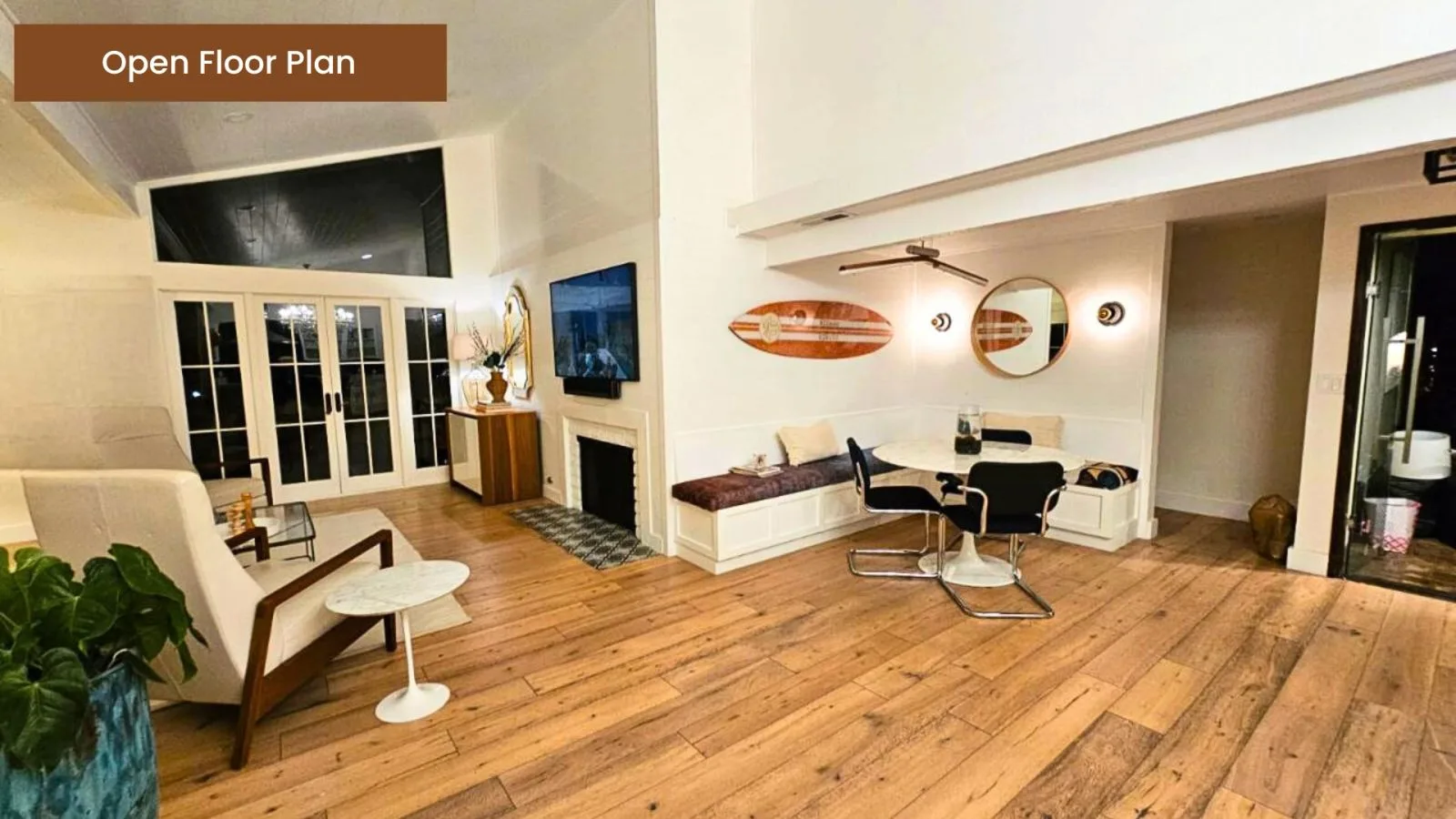 Open floor plan living space with wide-plank floors