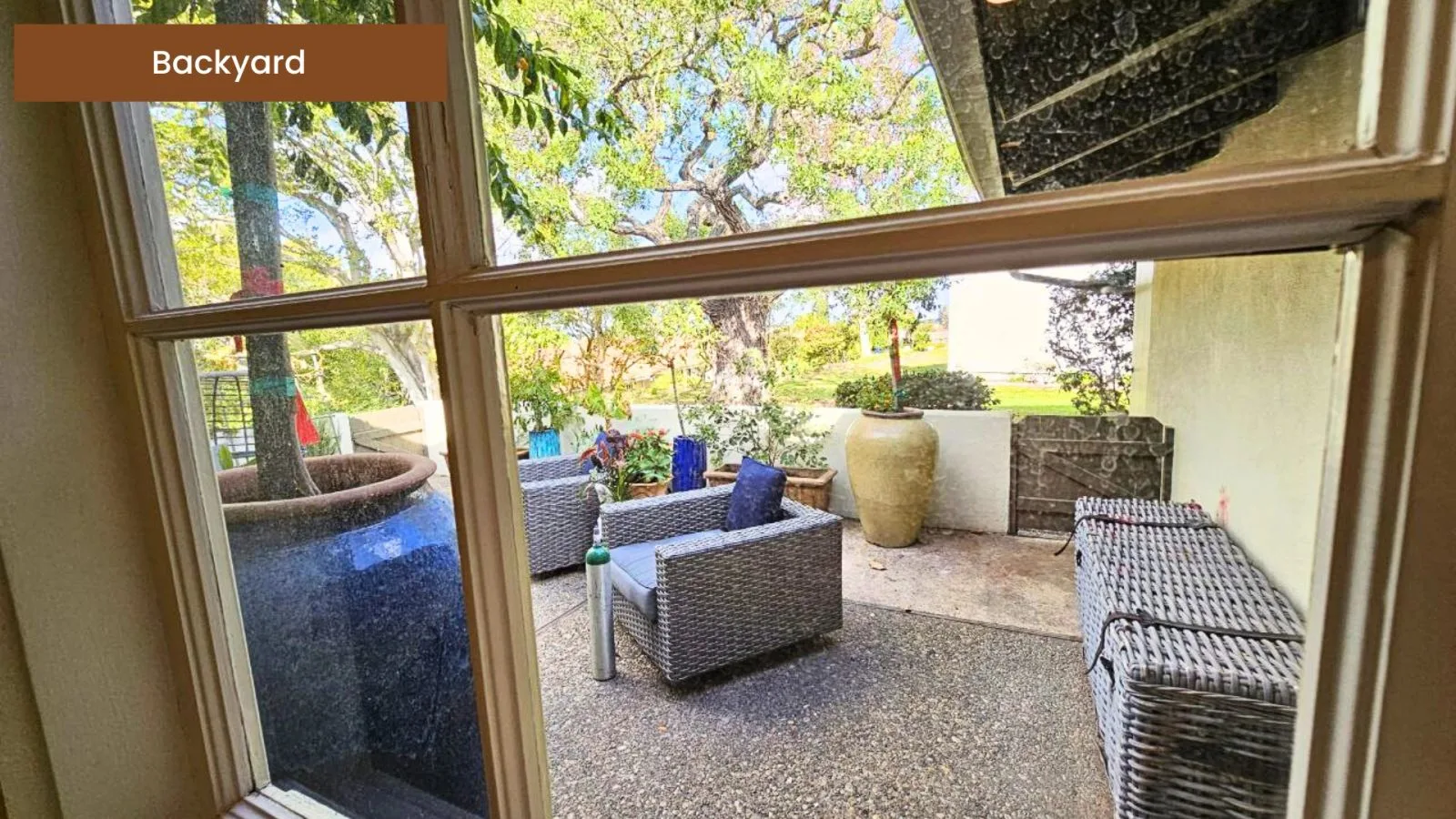 Covered backyard patio with lounge seating
