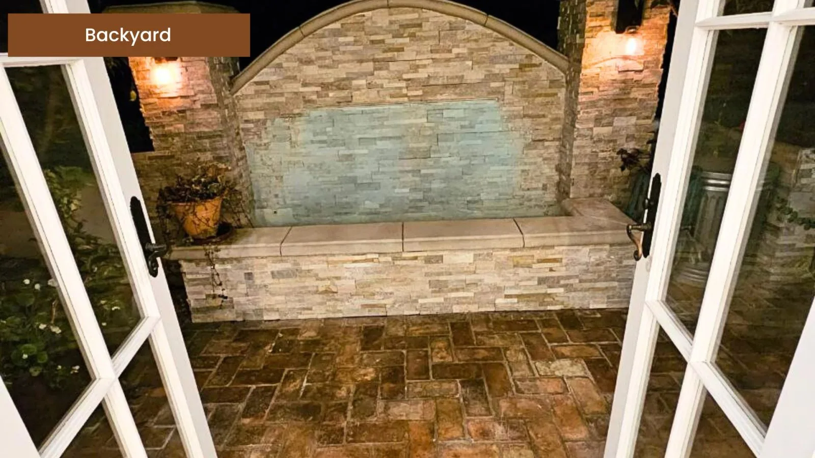 Backyard patio with an outdoor stone fireplace
